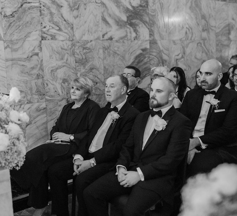 Wedding guests seated at their wedding ceremony 