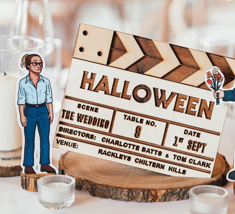 Halloween movie table name idea made on wood with characters as table centrepieces 