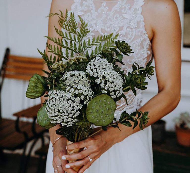 Bride carrying all green wedding bouquet 