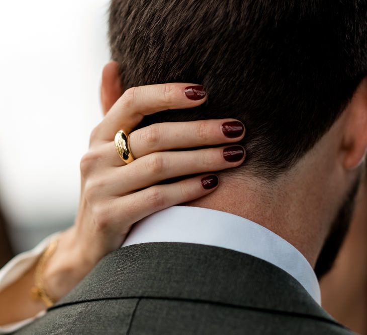 Dark red nails for bride at wedding with disco ball wedding decor