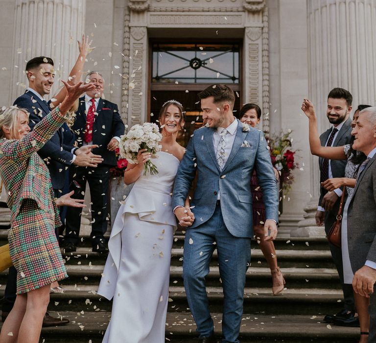 Confetti moment with bride in Roland Mouret strapless wedding dress