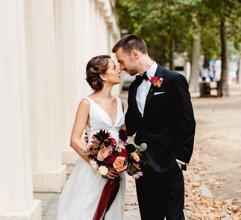 Bride and groom at autumn black tie wedding in London