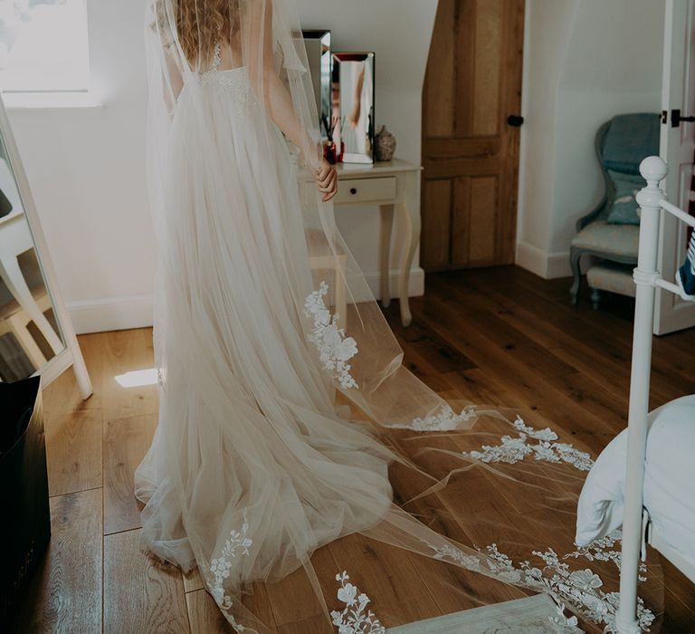 Bride in cathedral length veil with lace detail