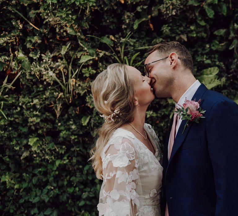 Bride and groom steal a kiss