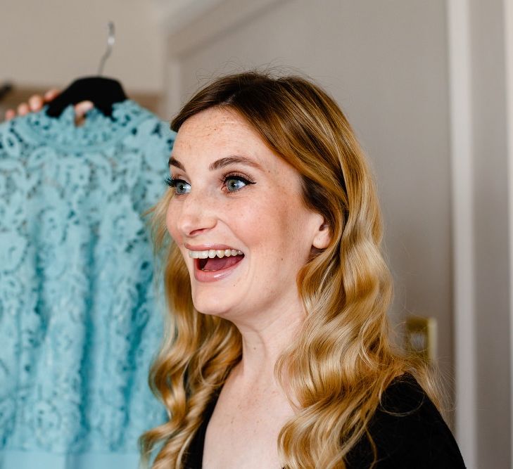 Happy bridesmaid with wavy hair on the wedding morning 