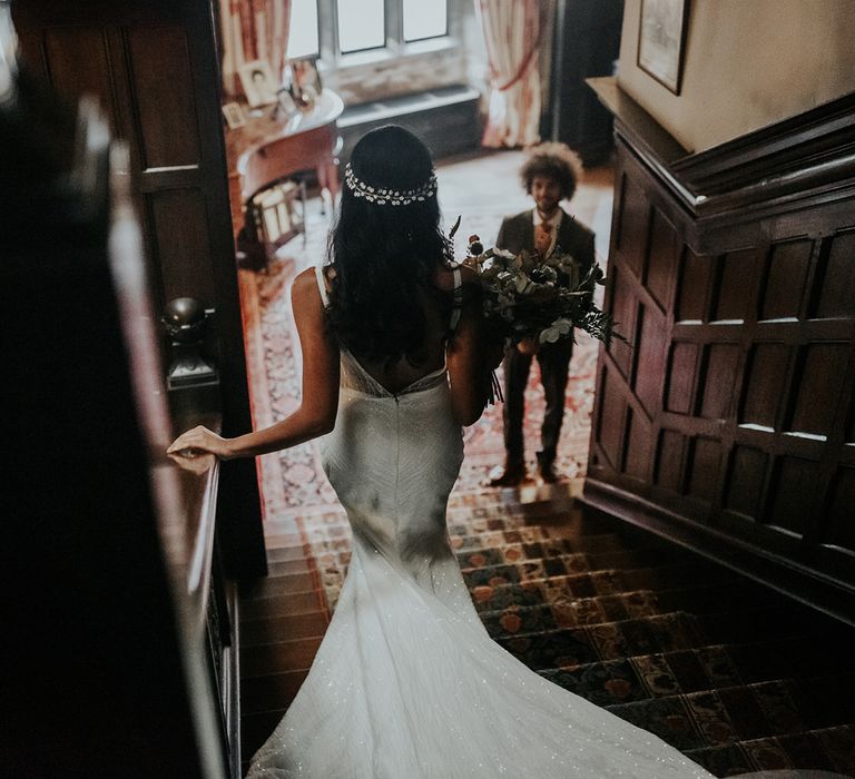 Bride in embellished wedding dress and hair vine walking down the stairs at Hooton Pagnell Hall