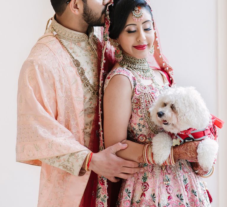 Bride and groom with their pet Bichon Frise dog