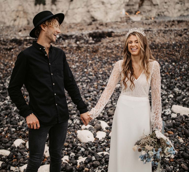 Bride and groom laughing at beach elopement 