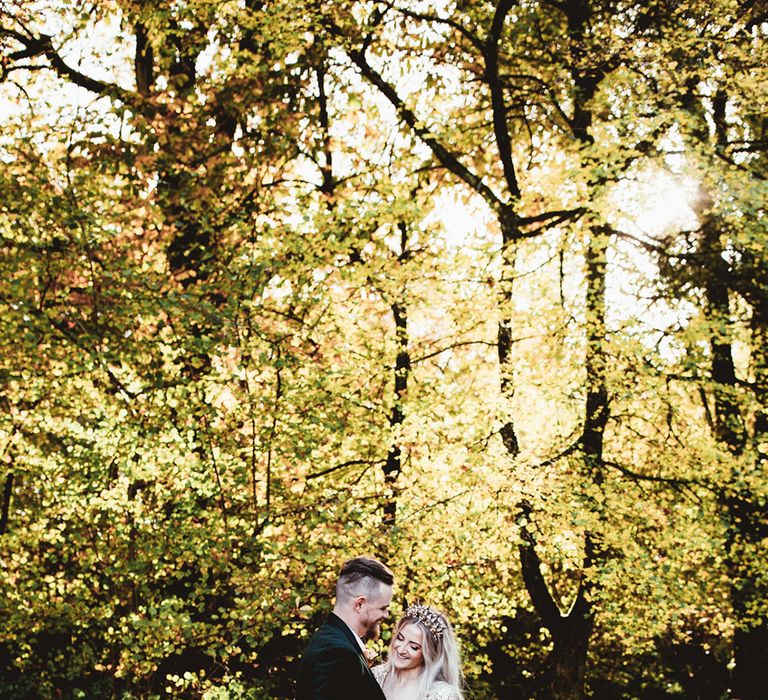 Bride and groom laughing in couple shot in the woods. Photography by Maryanne Weddings.