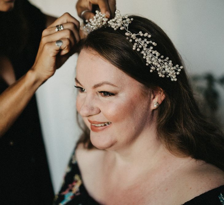 Bride having her hair accessories put in