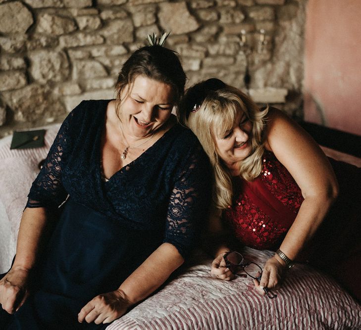 Guests laugh, with olive boquet details in their hair