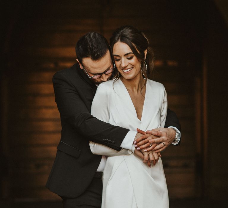 Groom embraces bride on wedding day 