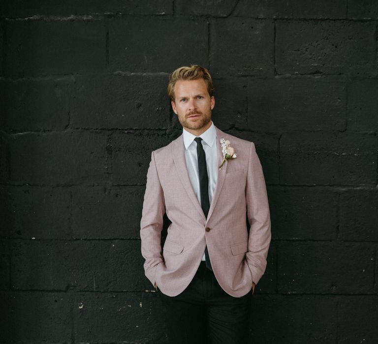 Stylish groom in black trousers and pink blazer at The Shack Revolution wedding venue 