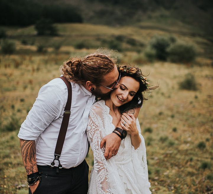 Groom embraces bride after wedding ceremony