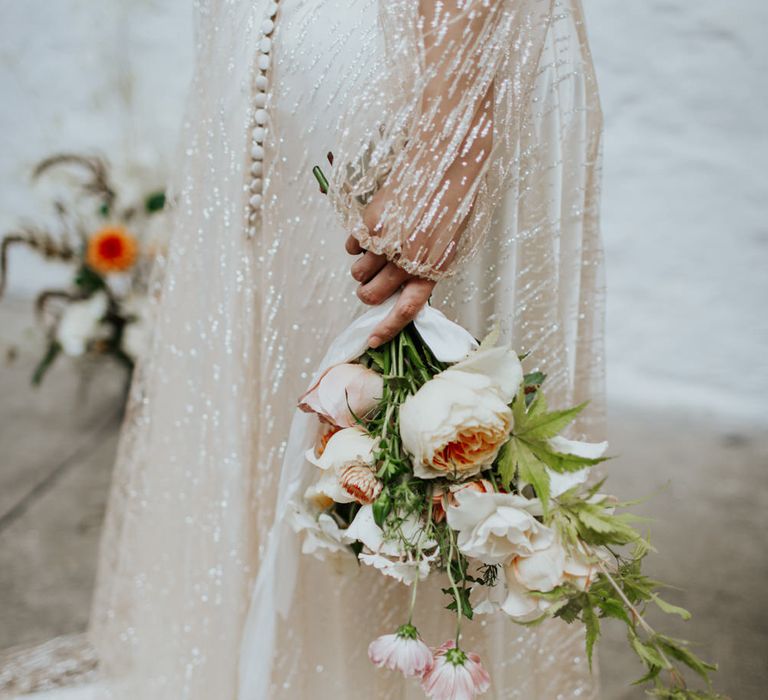 Button up back detailing on the layered mesh sparkly wedding dress.