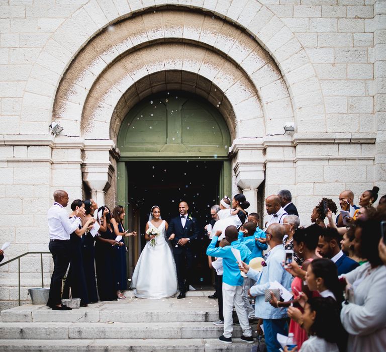 The guests blow bubbles over the bride and groom exiting the church rather than confetti