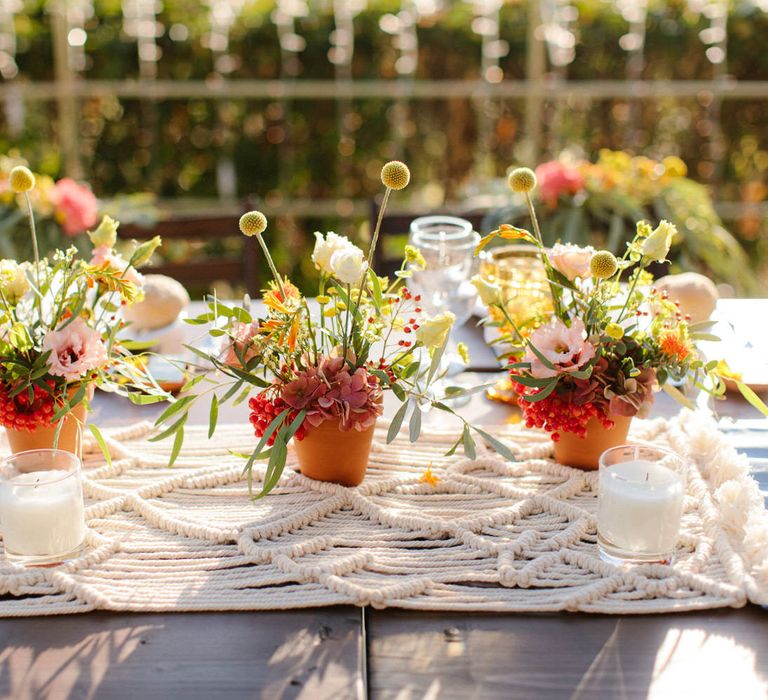 Macrame wedding table decor with terracotta flower pots and candles