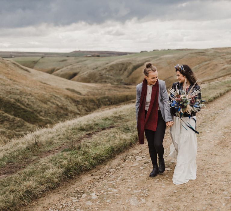 The brides walking through the Peak District in their ASOS wedding outfits