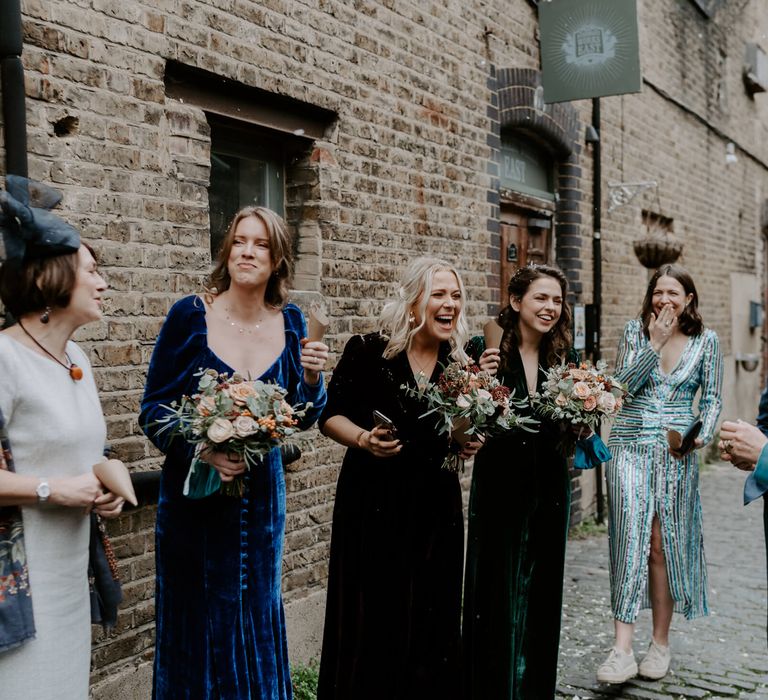 Wedding guests laughing at Clapton Country Club festive wedding