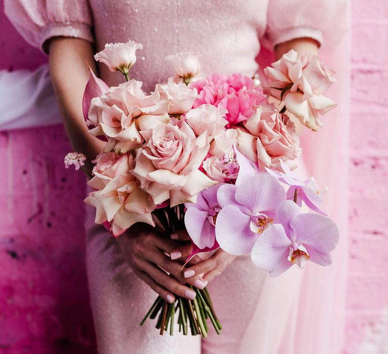 Pastel pink, lilac and fuchsia wedding bouquet with roses and orchid flowers 