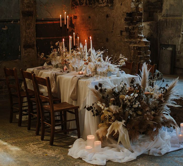 Intimate wedding reception at The Asylum wedding venue with dried flower centrepieces and end table floral arrangement 