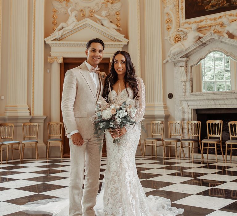 Bride & groom stand within regal room at the Orleans House Gallery 