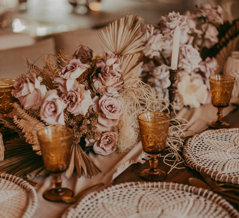 Florals next to woven placemats on wooden table