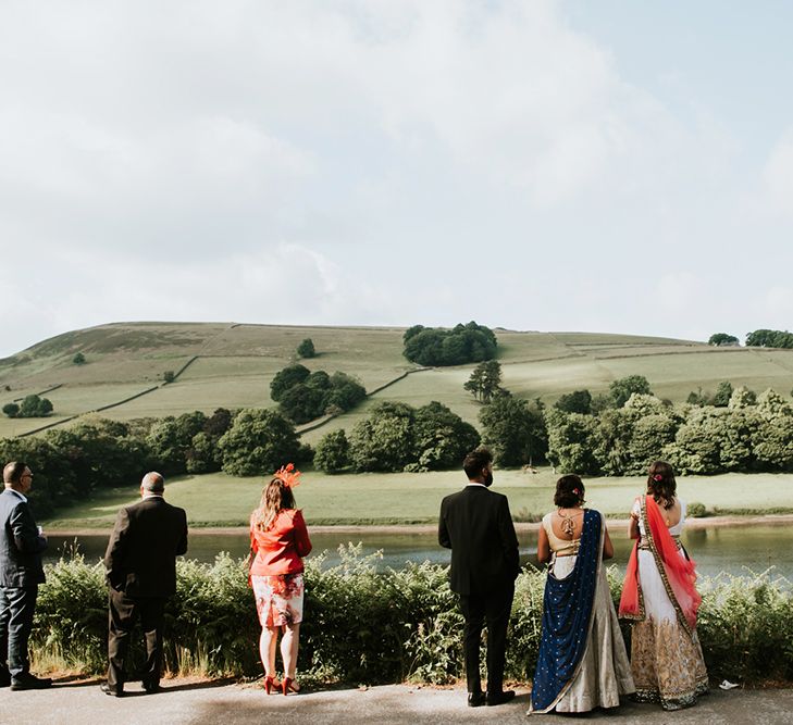 A wedding party look over scenery outside wedding venue. 