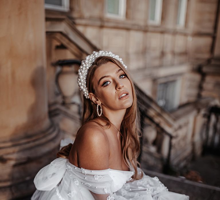 Strapless wedding dress with butterfly appliqué detail and bow back