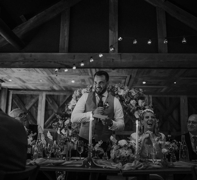 Groom in a waistcoat giving his wedding speech at Dewsall Court wedding reception 