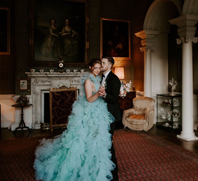 Bride in a light blue wedding dress dancing in the drawing room at her luxury black tie wedding at Newburgh Priory 