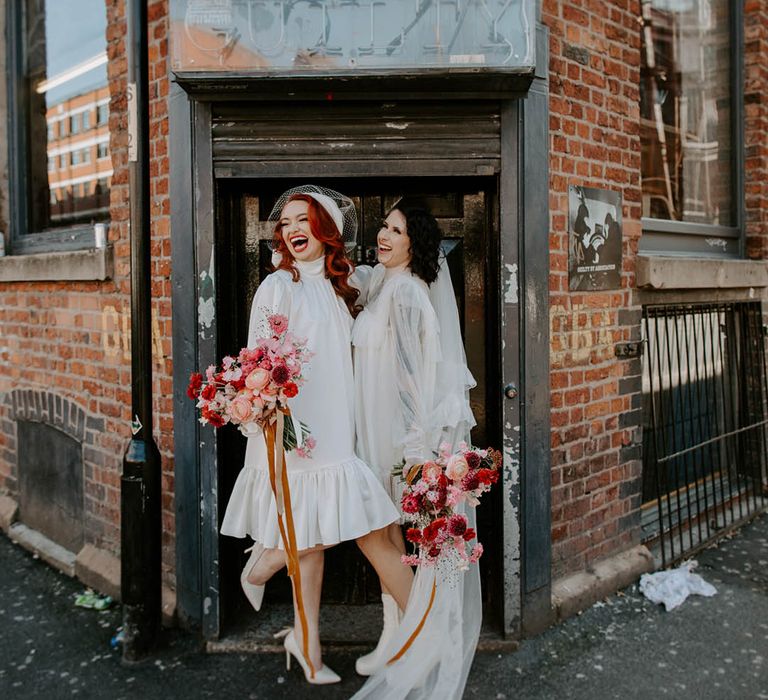 LGBTQI Mancester elopement with two brides in Moochild short wedding dress long veil and berret outfits 