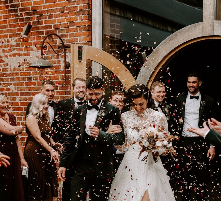 Bride and groom have their confetti exit to autumnal coloured confetti 