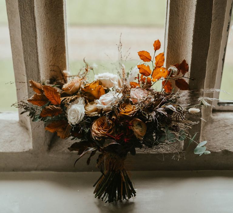 Rose wedding bouquet with autumn leaves for the autumn wedding at Oxnead Hall