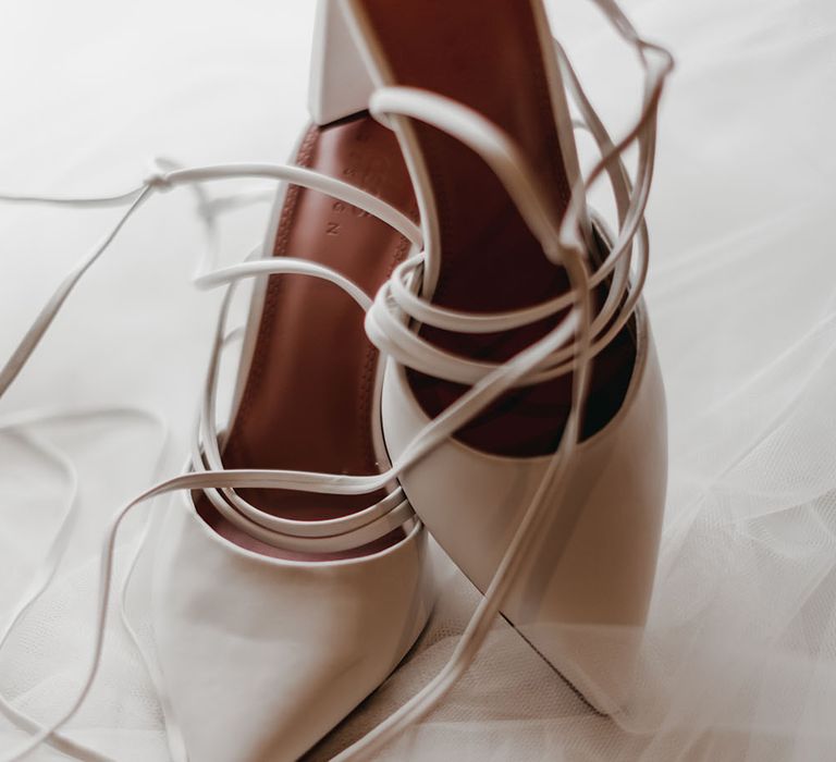 White pointed bridal heels with tie up straps 