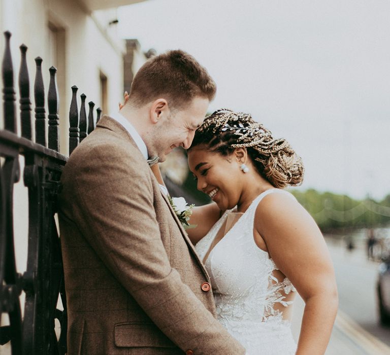 Bride with rounded natural style wedding nails laughs with the groom for their classic wedding in Bedford 