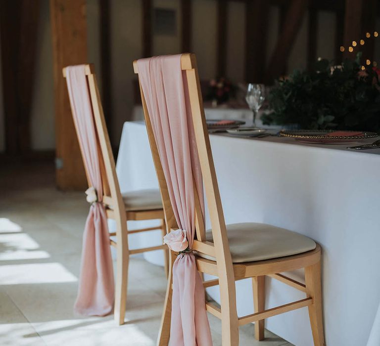 Pink material chair back decor with pink roses 