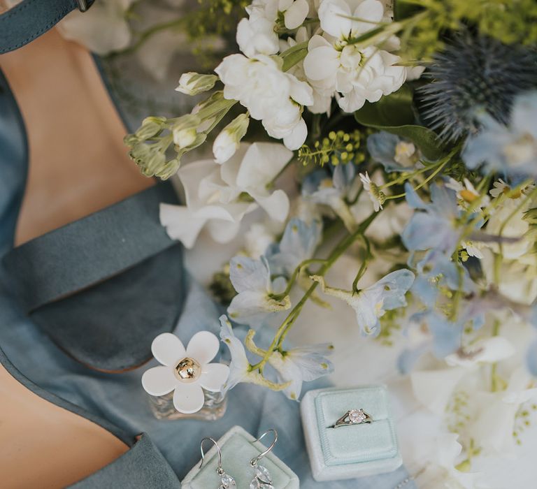 Blue suede wedding shoes with velvet jewellery boxes holding the ring and earrings with Marc Jacobs Daisy perfume wedding scent 