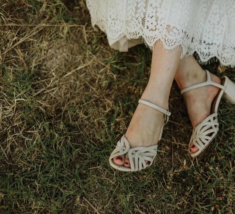 Bridal heels with cutout details paired with a lace wedding dress