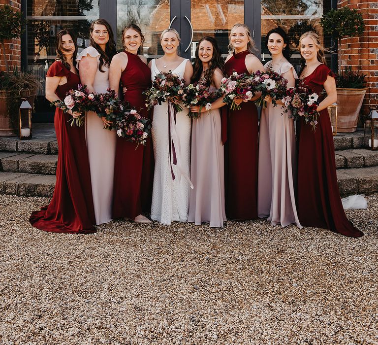 Bridesmaids in mismatched pale pink and burgundy bridesmaid dresses from Rewritten Bridesmaids 