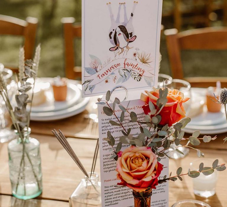 table name card and orange rose flower stem in a brown vase table centrepiece decor