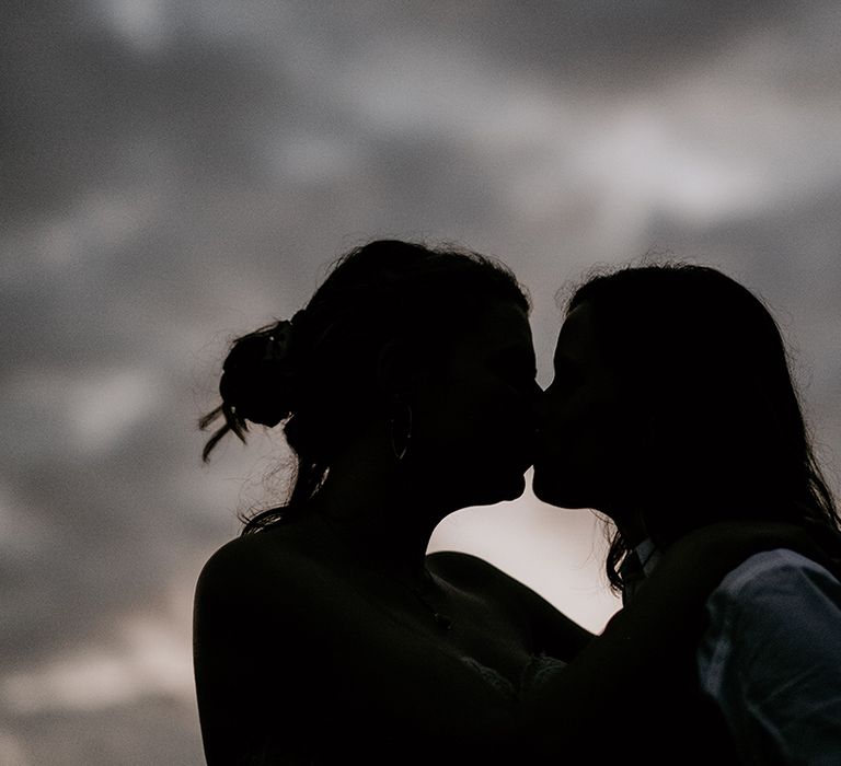 shadow wedding photograph of two brides kissing 