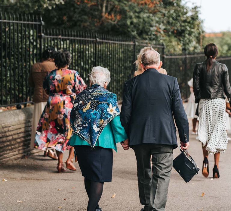 Wedding guests walk from the registry office to the wedding reception 