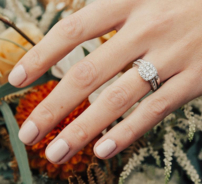 Pale pink neutral engagement nails in short squoval shape with halo setting platinum ring 