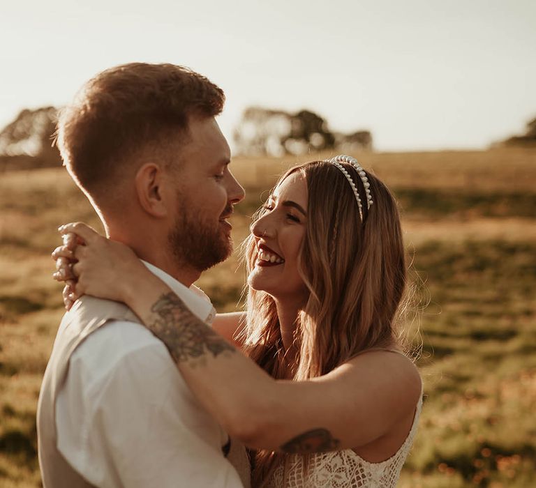 Golden hour photo of the bride and groom at their disco party wedding 