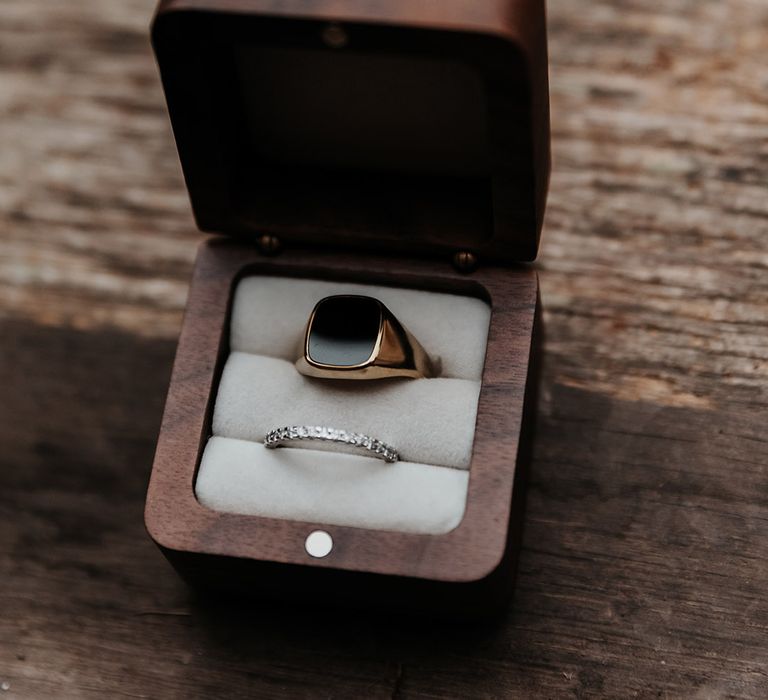 Diamond wedding band with groom's gold wedding band in ring box 