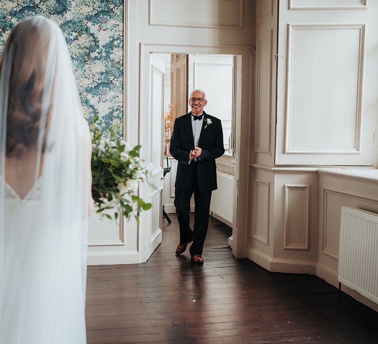 Father of the bride gets a first look at the bride 