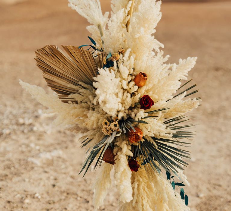 Dried palm leaves and pampas grass on moongate altar decoration 