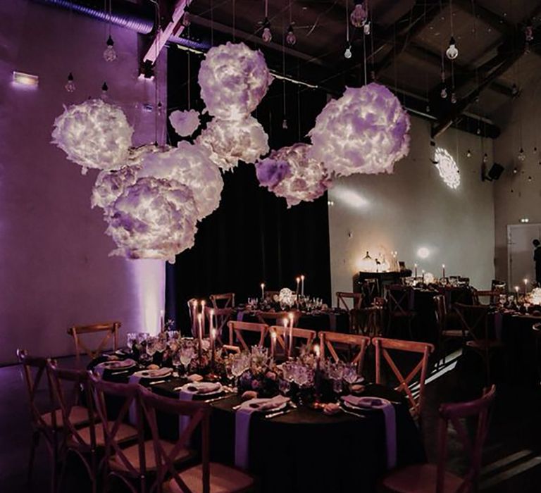 Cloud shaped lights hanging above table by Lyse Kong Photography