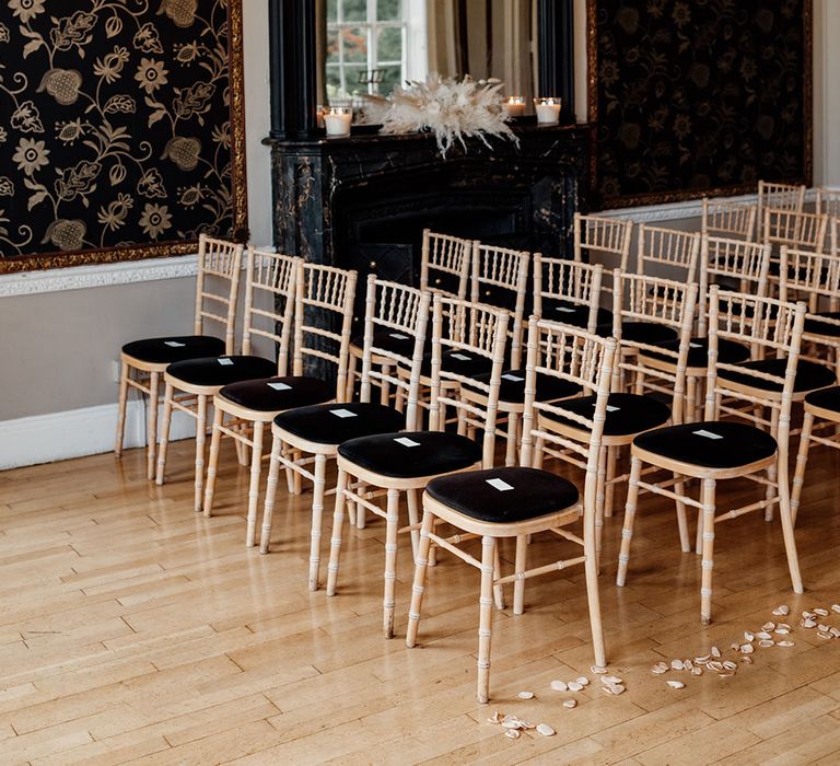 Nonsuch Mansion wedding with black chairs and petals for aisle decoration 